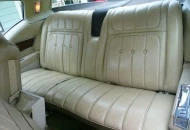 White leather 20/40 bench seat in the back.